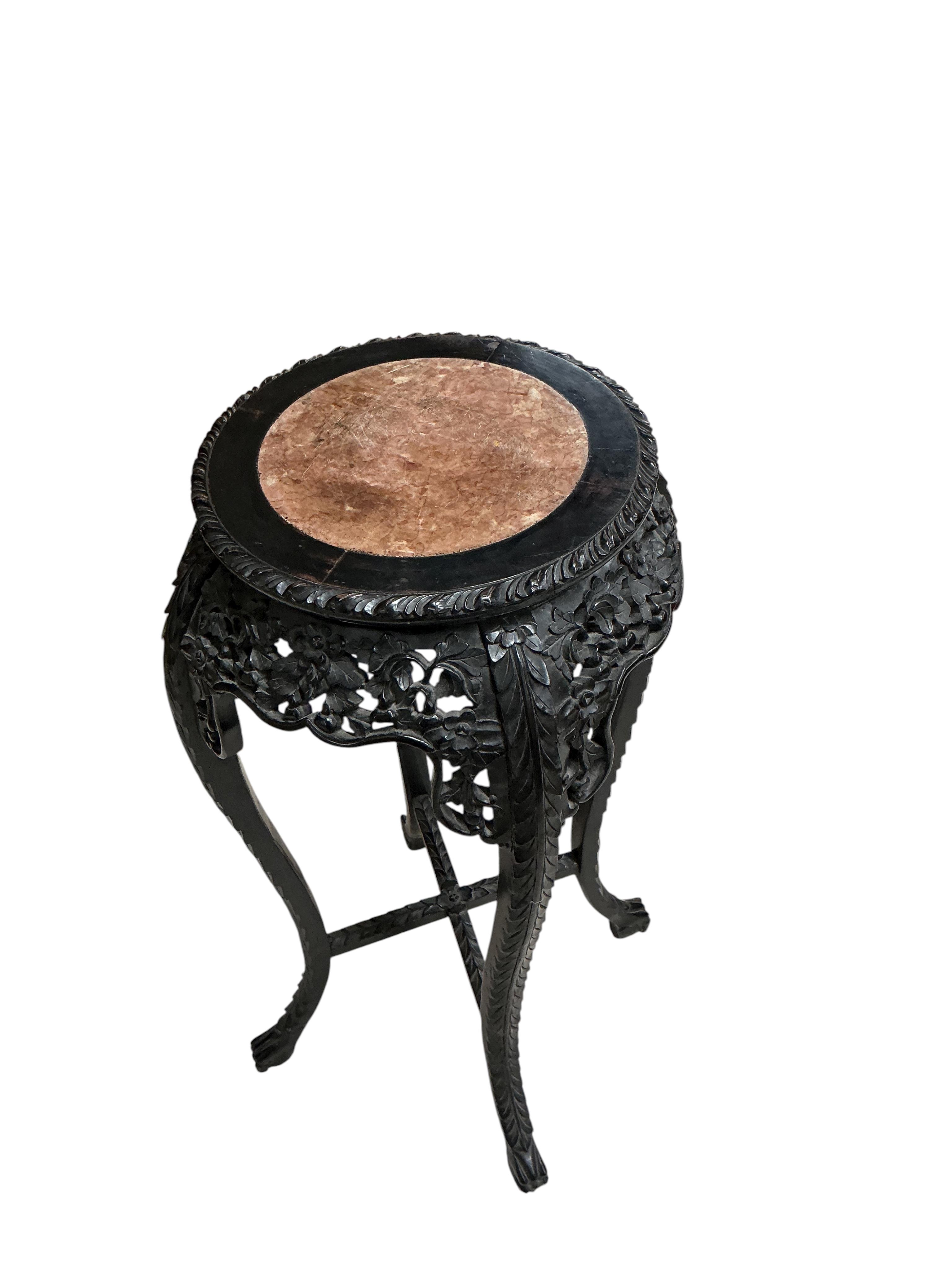 A Chinese circular rouge marble topped carved hardwood vase stand, diameter 44cm, height 91cm